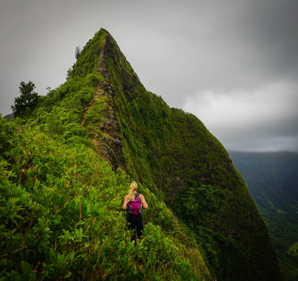 Woman hiking on a ridge in Hawaii