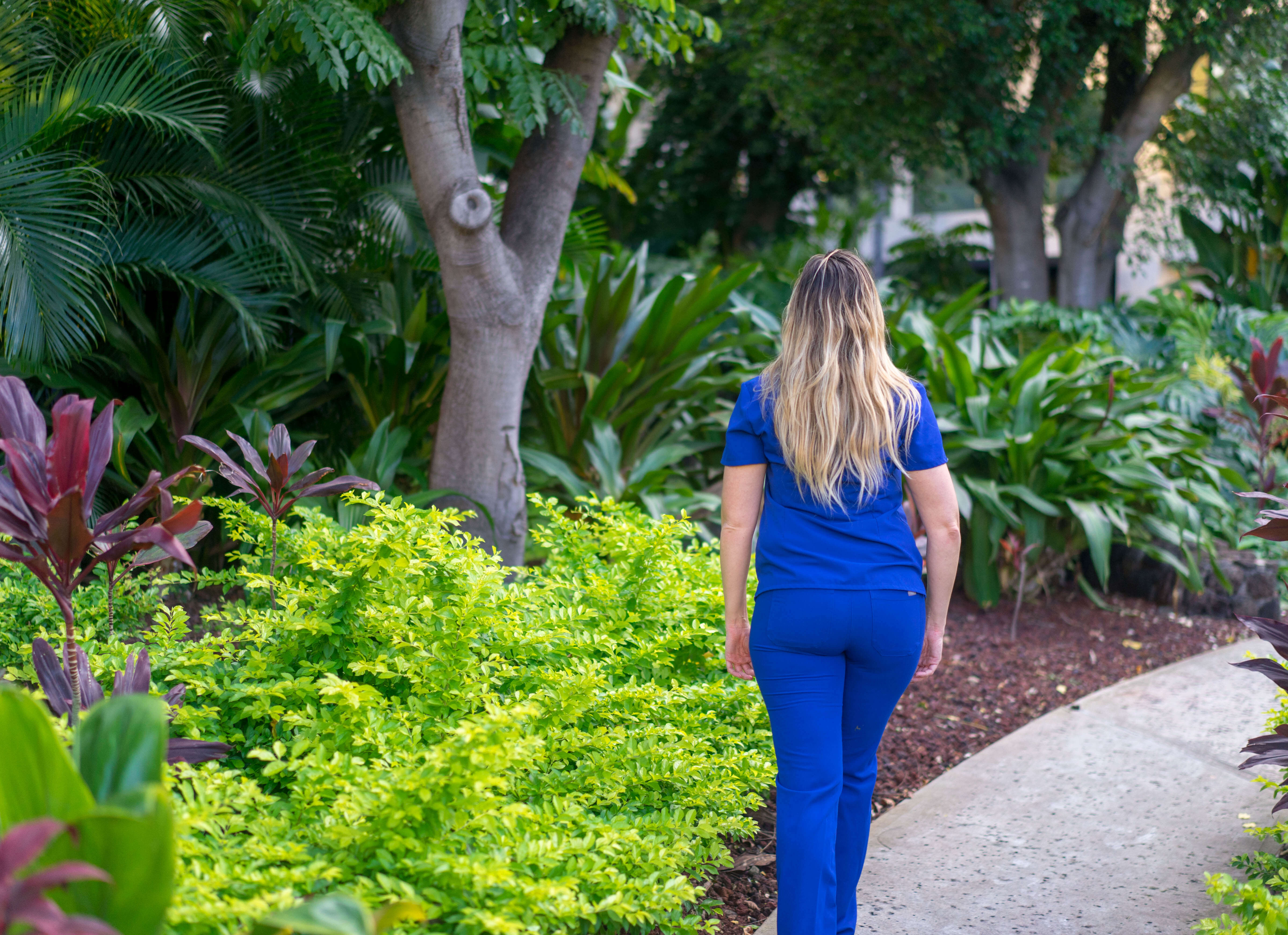 a women in scrubs walking on the payment