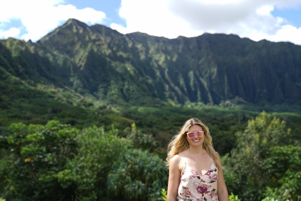 a women standing in front of a mountain