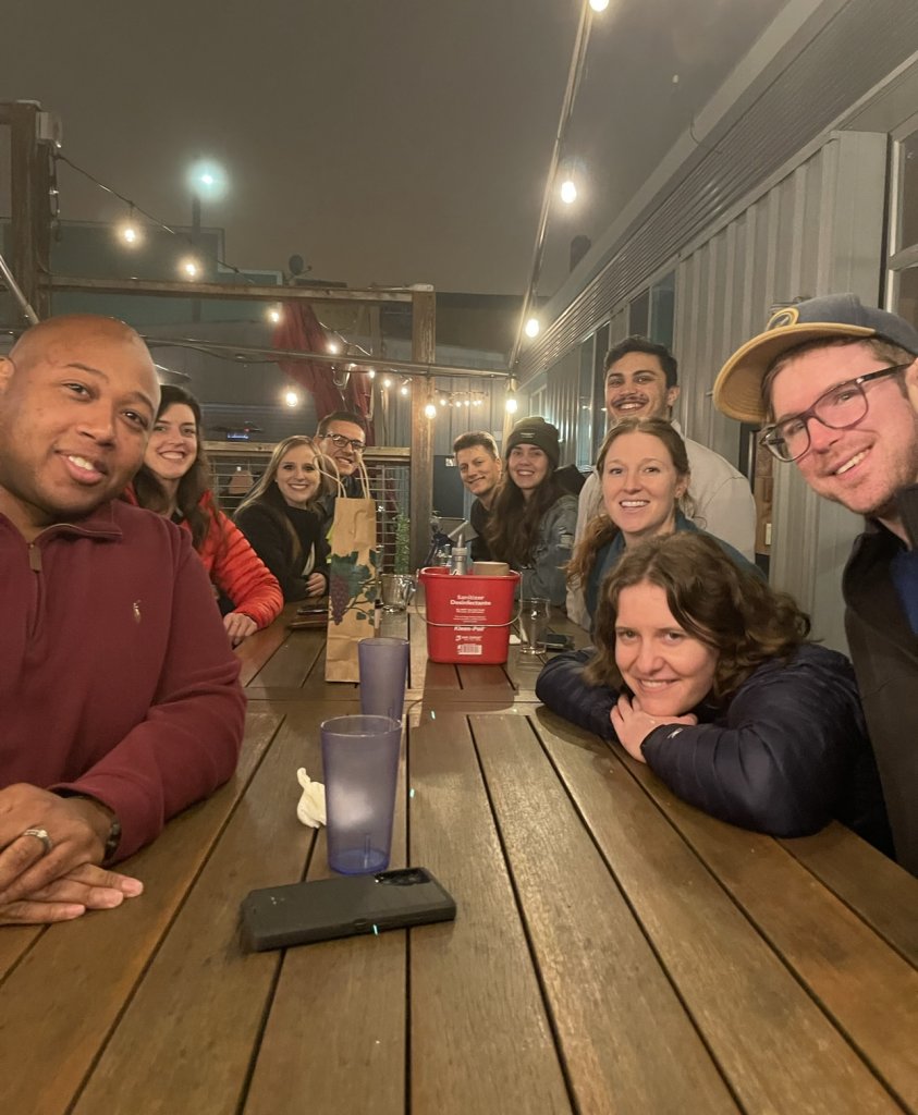 a group of traveling therapists sitting at a table together in a restaurant 