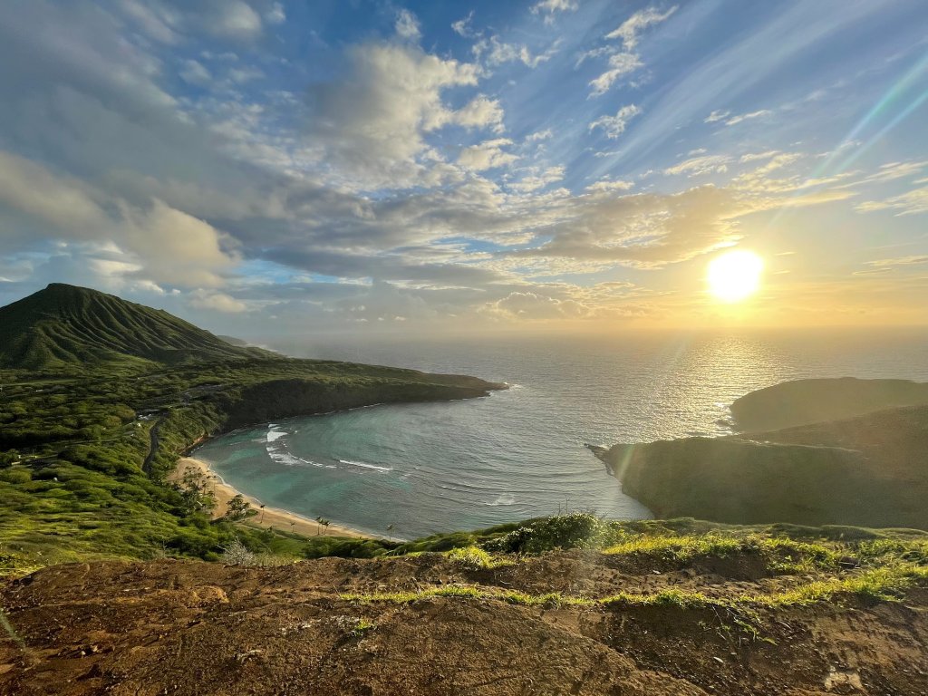 picture of a beach with the sun rising over it in Hawaii 