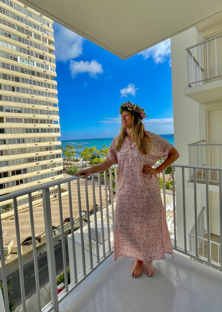 a women standing on a patio in waikiki beach
