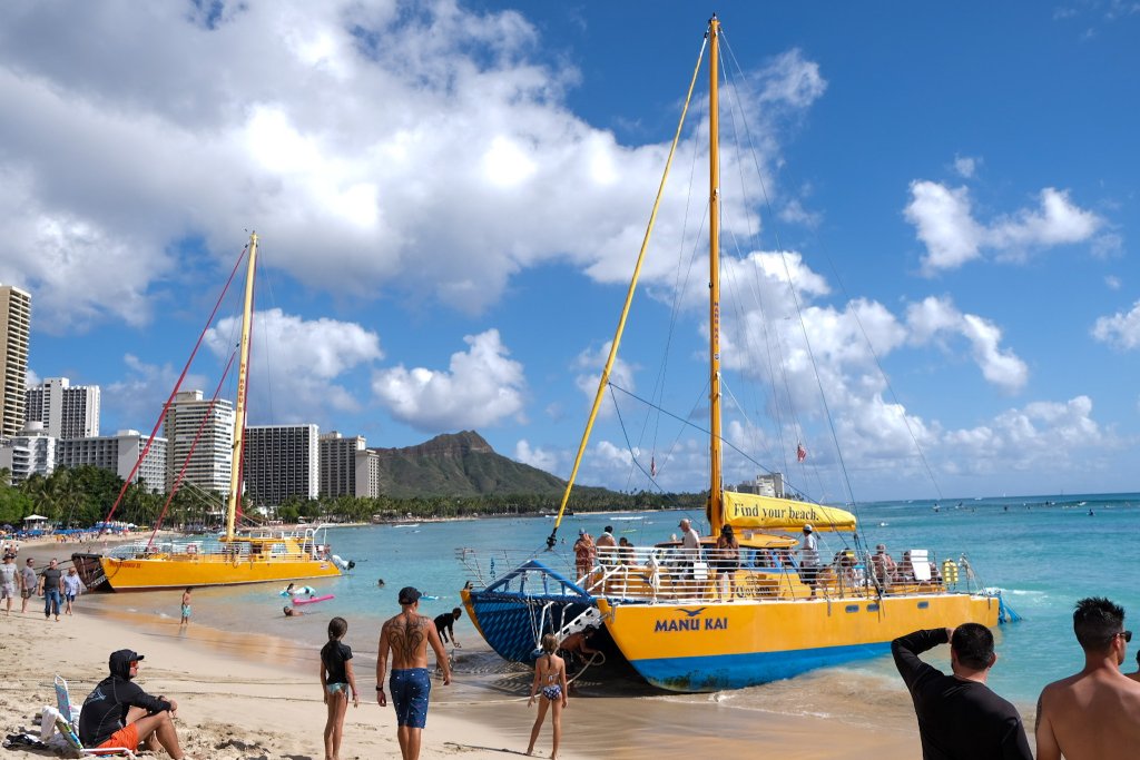 2 boats sitting along the beach