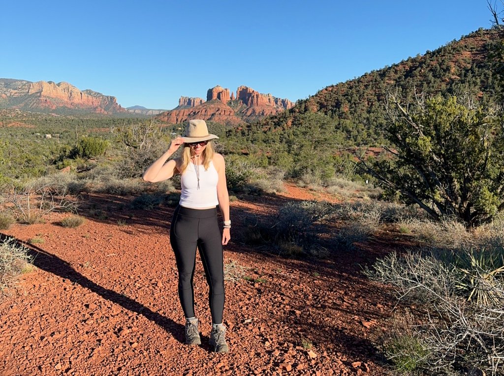 a woman standing on red rocks in Sedona