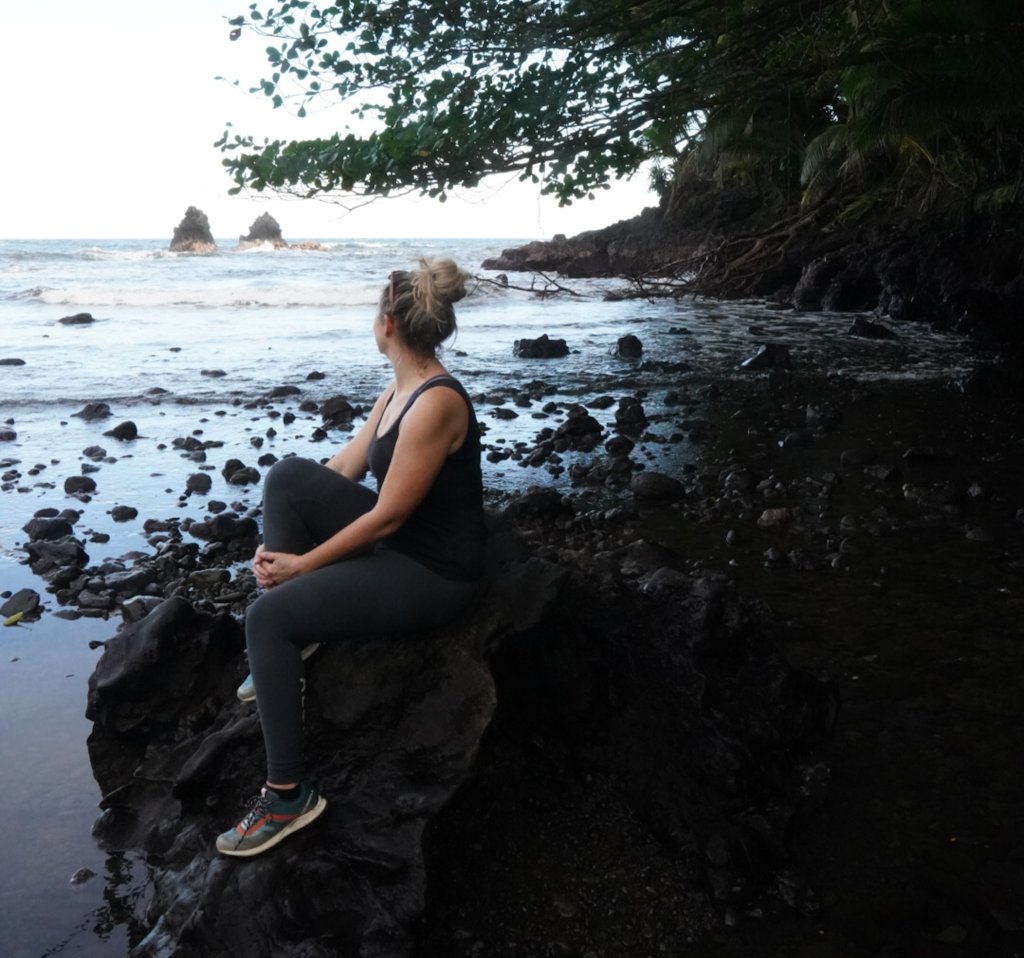 a women sitting on the beach in Hilo