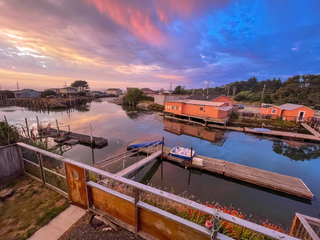 a picture of a sun setting over a dock