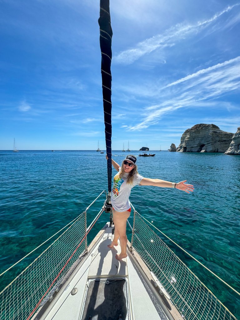 a woman standing on a boat in Milos, Greece