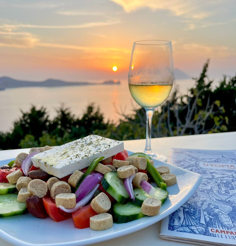 food and a glass of wine at sunset